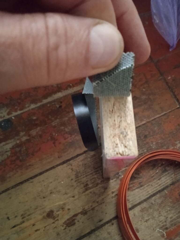 Macro photo proving you can cut particle board without chipping when using the thermal transfer edge banding hack
