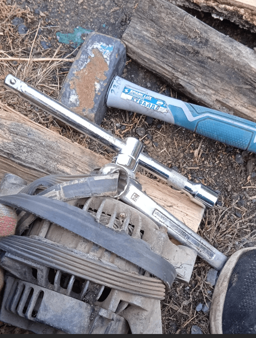 Removing alternator pulley nut with hand tools after using a car noise diagnostic tool
