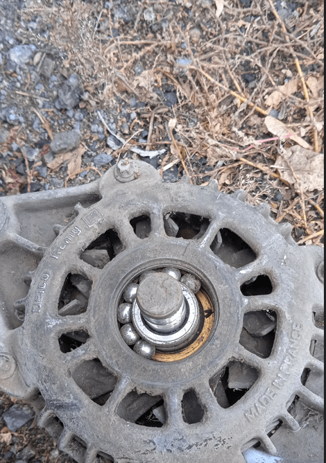 Exposed front bearing on a Delco Remy alternator after removing the pulley