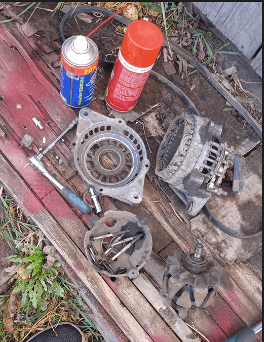 Alternator rotor and stator windings exposed during a DIY teardown